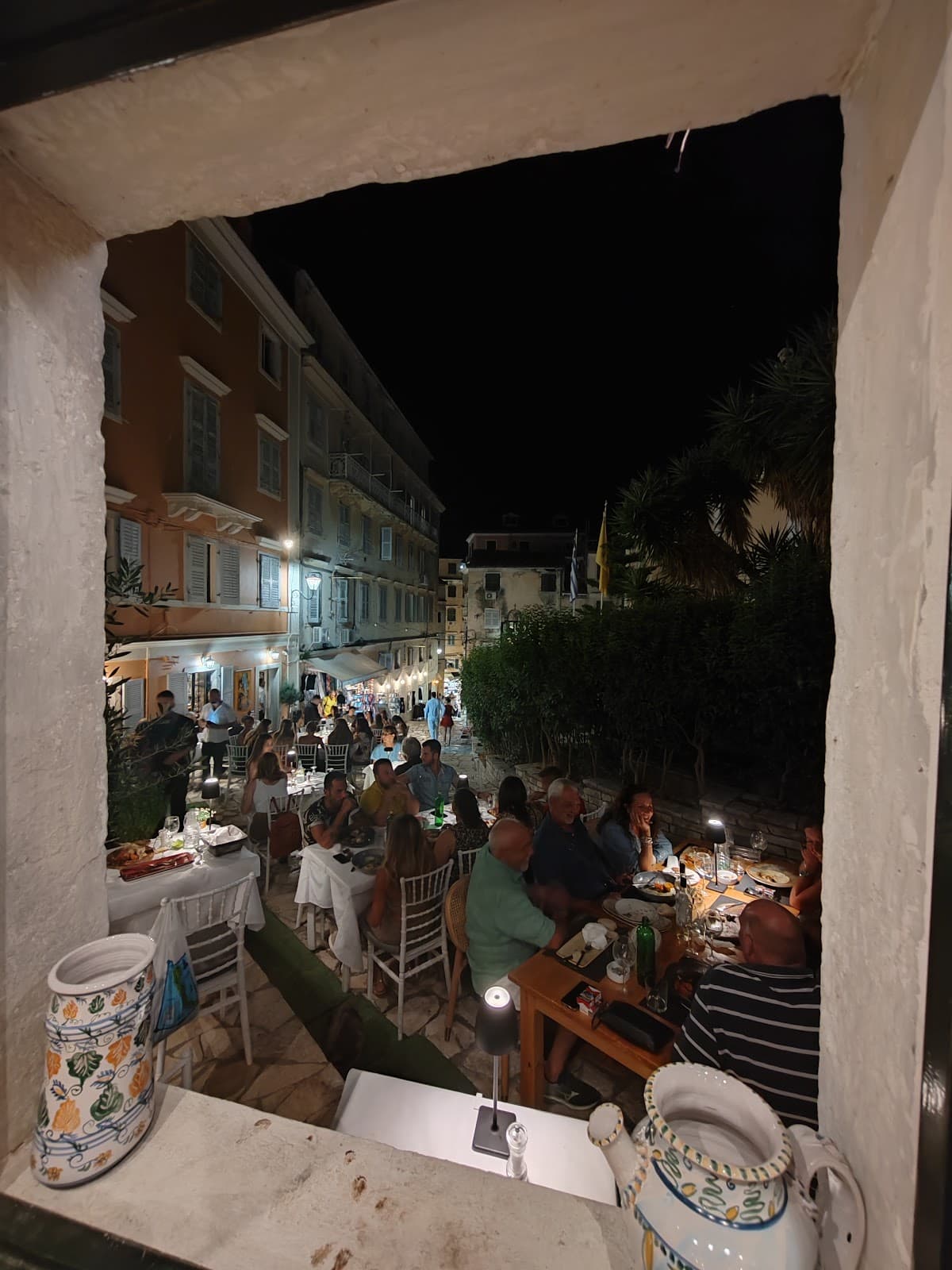 Terrace at night with bustling window view